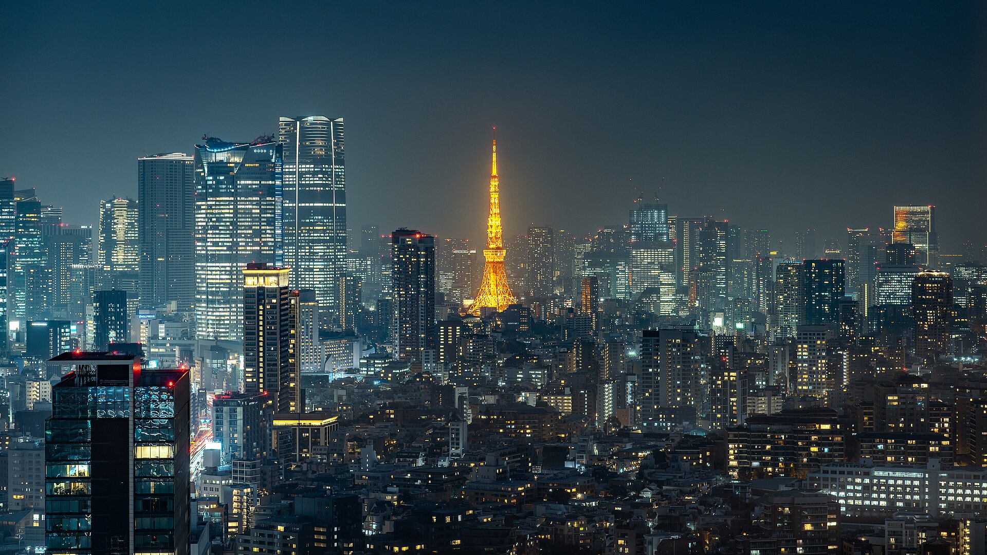 Tokyo Tower glowing above the Minato City skyline at night